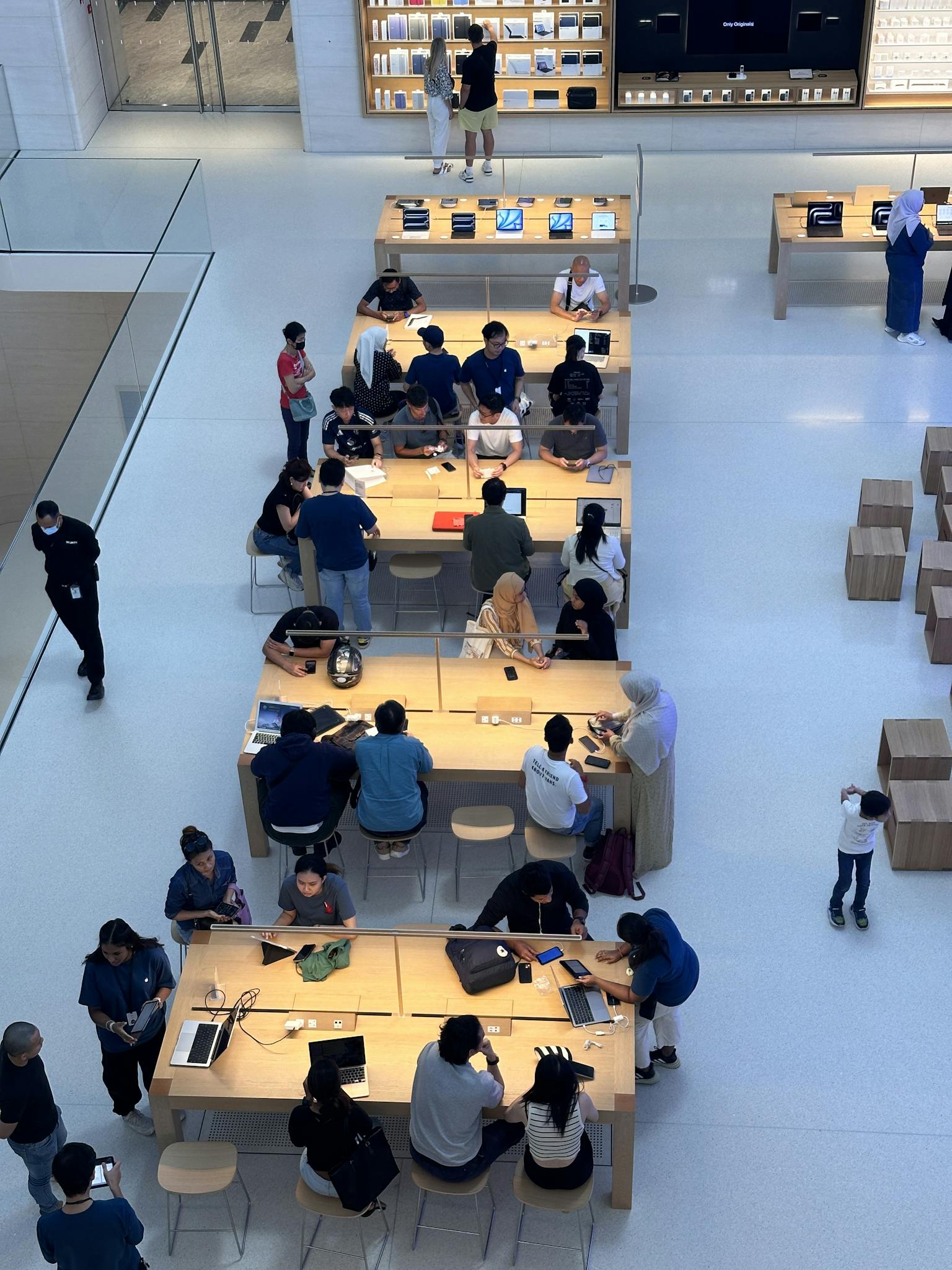 A dynamic interior view of a tech store with people engaging in Kuala Lumpur mall.